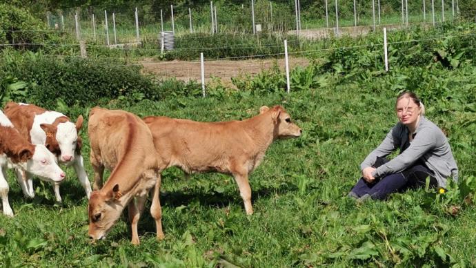 Eleveuse auprès de ses vaches dans un pré